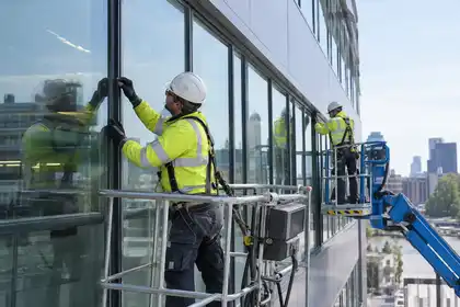 Technicians carrying out planned curtain wall maintenance