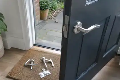 Door handles and replacement fittings beside a residential entrance.